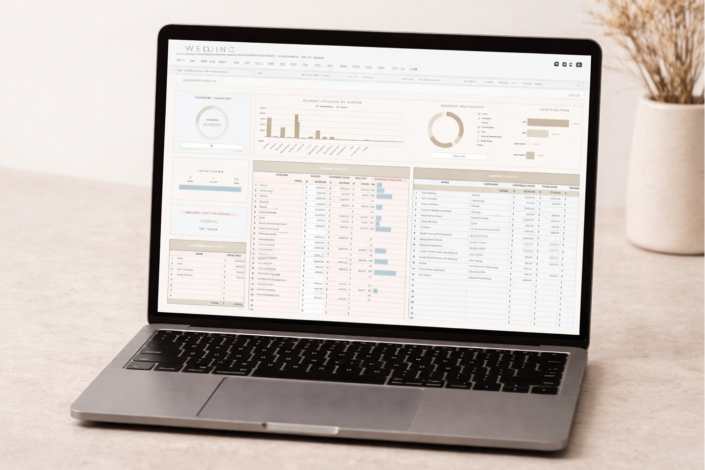 Laptop on a desk with a spreadsheet on the screen